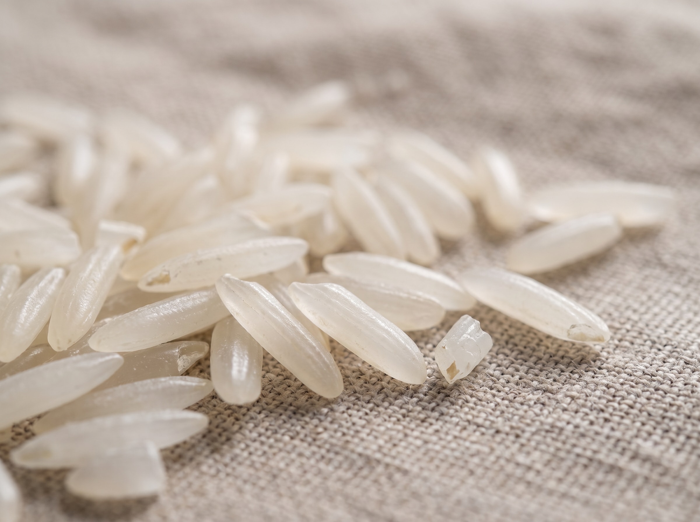 Close-up of premium Tarom Hashemi rice grains on a rustic surface